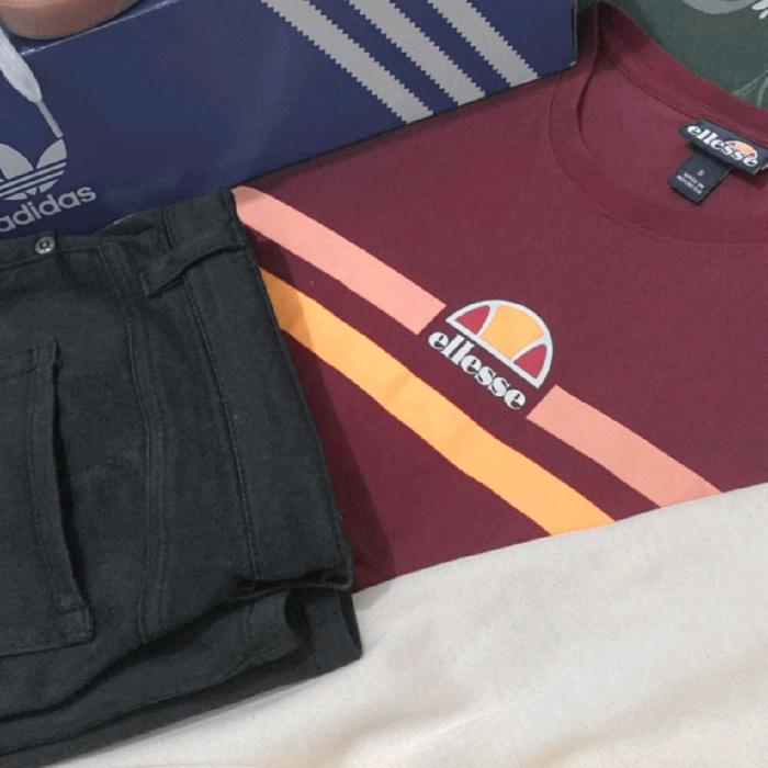 Ellesse Kaos Pria Maroon dengan Desain Garis Warna-warni dan Logo Ellesse di Dada
