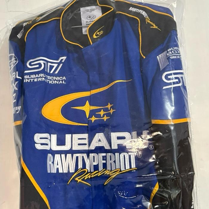 Subaru Rawtype Riot Racing Jaket Balap Biru dengan Logo Subaru Tecnica International dan Rawtype Rio