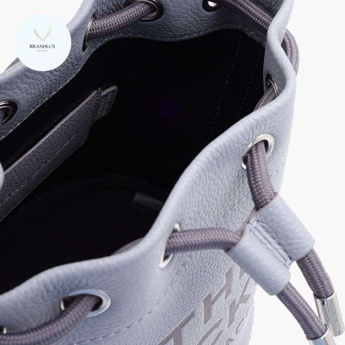 MJ EMBOSSED LOGO BUCKET BAG IN WOLF GREY LEATHER