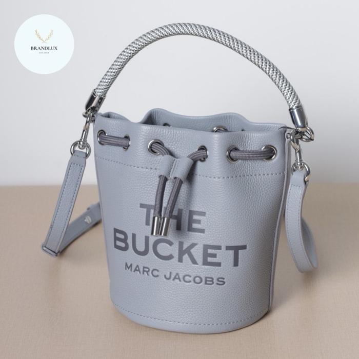 MJ EMBOSSED LOGO BUCKET BAG IN WOLF GREY LEATHER