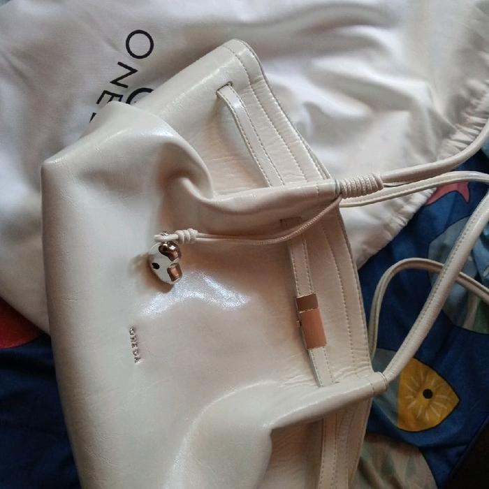 tas oneda original