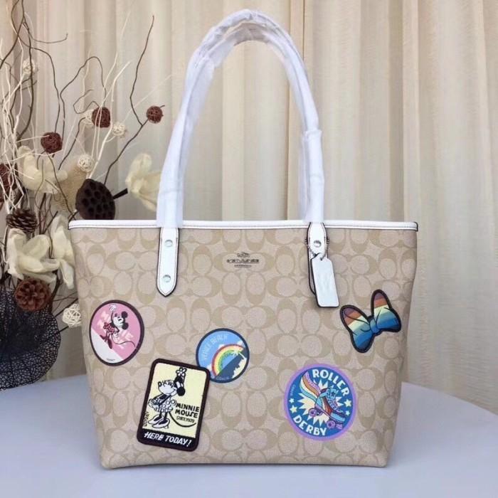 Tas COACH X Disney City Zip Tote Bag in Signature Light Khaki